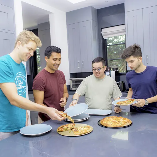 Group of Best Buddies living roommates having pizza together